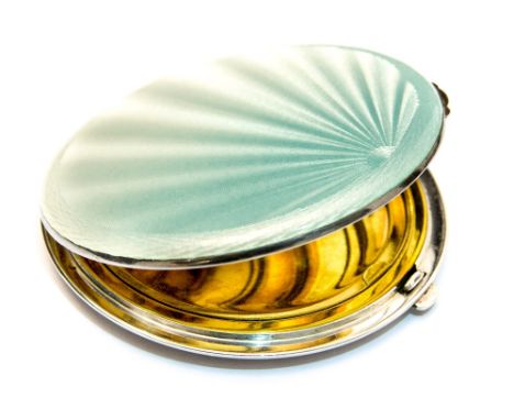 A 1940s enamelled silver compact, circular form, turquoise draining to white enamel guilloche starburst design, Crisford and 