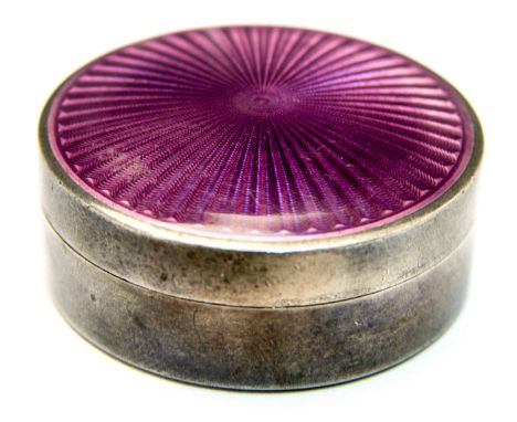 A German silver and guilloche enamel pill box, circular form, the lid with purple engine turned starburst enamelling, gilded 