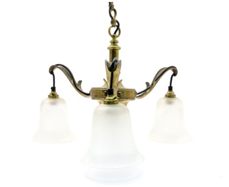 An Arts and Crafts copper ceiling light, three branches with frosted shades, Art Nouveau style
