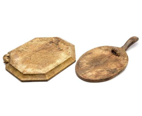 Robert Mouseman Thompson of Kilburn, two Arts and Crafts carved oak bread and cheese boards, one of octagonal form, the other