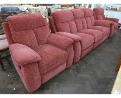 A three seater settee and three piece lounge suite in dark pink material, one chair is an electrical recliner and one chair i