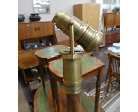 A walking stick with brass telescope handle 
