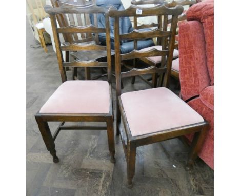 A set of four oak ladder back dining room chairs with pink upholstered seats 