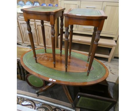 An oval reproduction mahogany and green leather coffee table, a pair of similar lamp tables, wine table and a magazine rack 