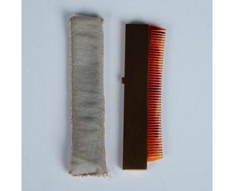 This beautiful gold tone retractable case is decorated with mother of pearl. It has the original comb inside and cloth pouch.