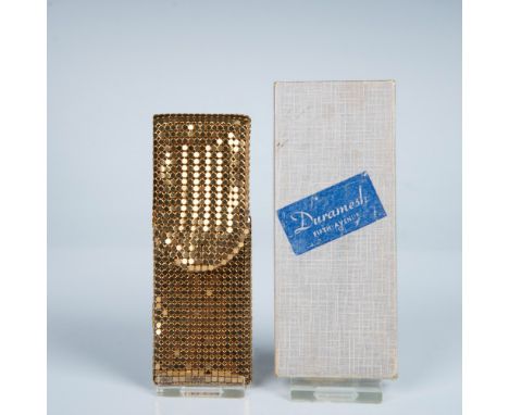 This vintage mini grooming kit includes a gold metal nail file and comb inside a gold metal mesh carrying pouch that measures