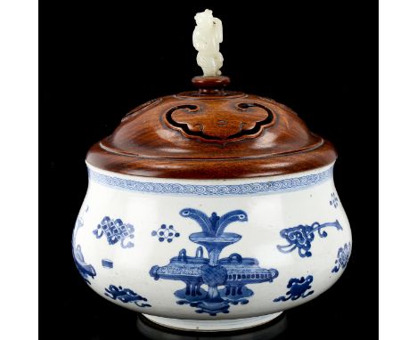 A Chinese Kangxi blue and white porcelain lidded censer, of bulbous circular form, with painted designs of ceramics and ornam