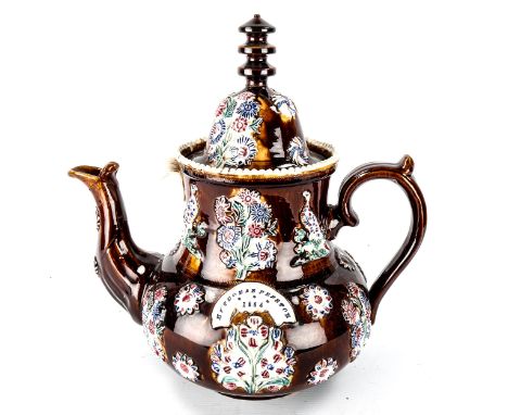 A large 19th century Barge Ware pottery teapot, with relief moulded decoration and name panel inscribed Mr Thomas Preston 188