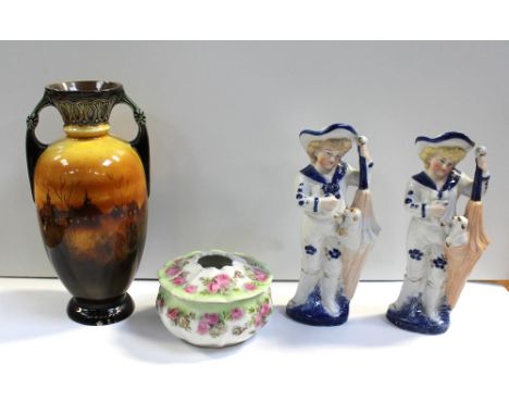 A pair of 19th century Continental ceramic figures of boys with umbrellas and a dog, height of each 18cm, a twin-handled balu