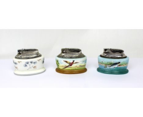 Three Minton hand-painted ceramic table lighters; one painted with leaping salmon, signed A. Holland, a pheasant flying over 
