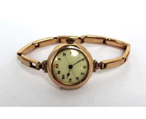 Rolex; a 9ct gold ladies' wristwatch, enamel dial set with Arabic numerals (af), on a 9ct gold expandable strap, approx 26g. 