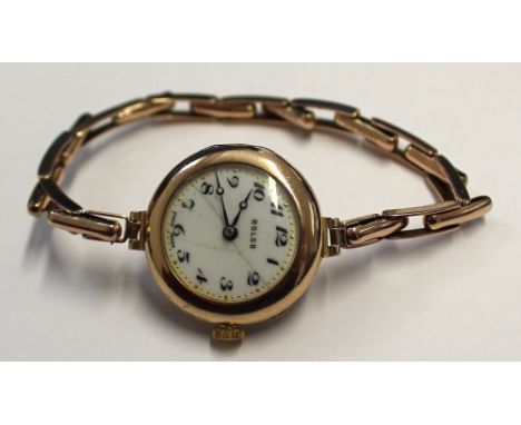 Rolco; a 9ct yellow gold ladies' wristwatch, white enamel dial set with Arabic numerals, on associated yellow metal bracelet 