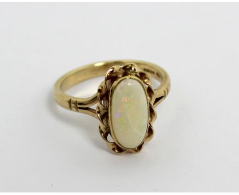 A 9ct yellow gold and oval opal-set dress ring, size M 1/2, approx 3g.