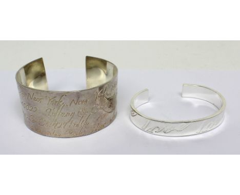 A wide silver bangle, marked '925', engraved 'Fifth Avenue, New York' and one other silver bangle marked '925', engraved 'Lov