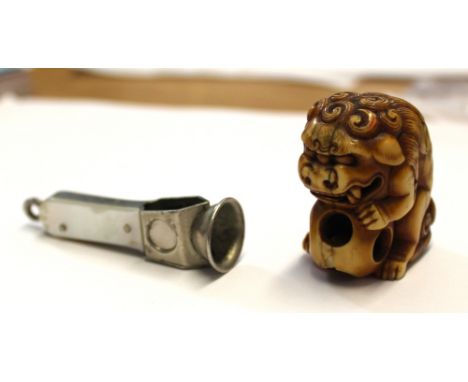 A white metal and mother of pearl cigar cutter and a netsuke of a Dog of Fo (2).