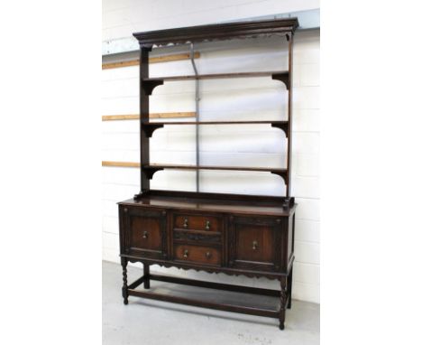 An early 20th century oak dresser with three-shelf plate rack, the base with an arrangement of two drawers and two cupboard d