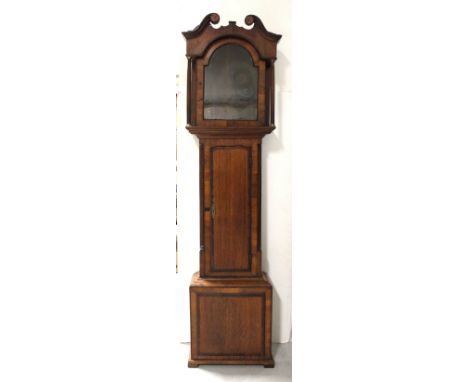 An early 19th century oak and mahogany cross-banded longcase clock case with associated walnut veneered hood, long arched doo