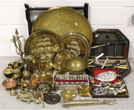 A collection of brass and copper items to include wall plaques, candlesticks, fire tools and an Egyptian tray-topped table, a