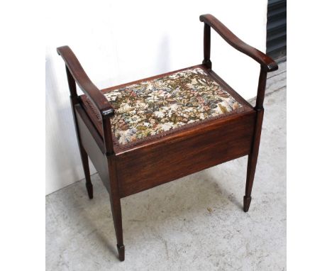 An Edwardian oak piano stool with tapestry, floral decoration to seat and tapering supports to peg feet, height 63cm, width 5