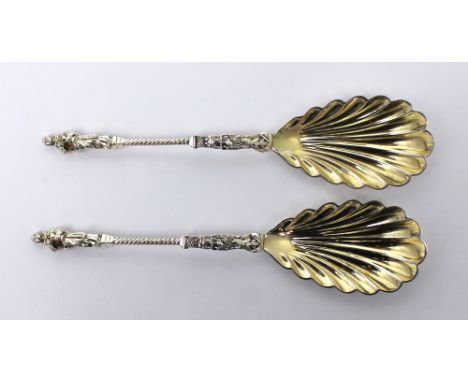 A cased pair of Victorian hallmarked silver Apostle serving spoons with scallop moulded gilt-washed bowls and wrythen twisted