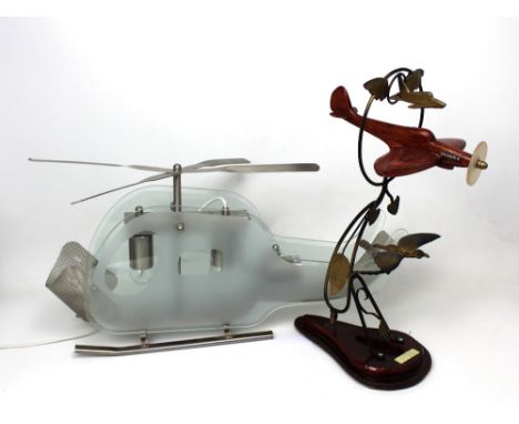 A glass and chromed metal lamp modelled as a helicopter, length approx 60cm and a wooden model plane above bird with plaque, 
