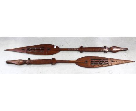 A pair of early 20th century ornamental paddles (possibly from New Zealand), one end carved in the form of a crocodile, lengt