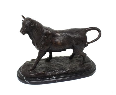 After Barye; a modern bronze figure of a bull on an oval plinth, length 35cm.