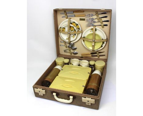 A vintage Brexton picnic set with contents including ceramic teaware, Thermos flasks etc.