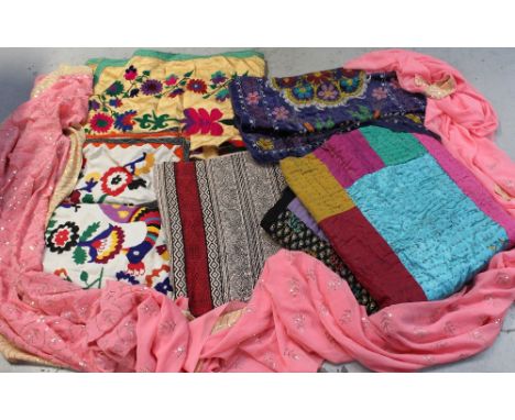 A quantity of Indian textiles to include hand-embroidered, bead and sequin decorated throws, cotton, linen and silk-effect th