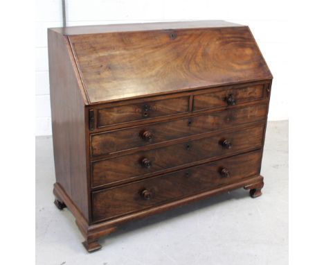 A 19th century walnut drop-down bureau, one small central door to interior flanked by decorative pillars and pigeonholes, fou