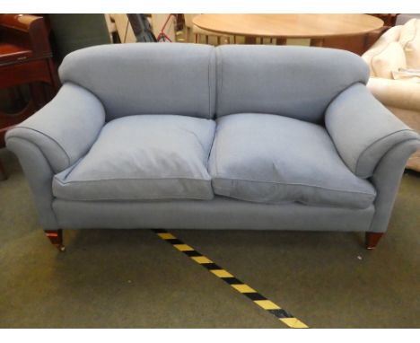 A good, blue upholstered sofa on mahogany legs to castors,&nbsp; stamped to inside back leg, Howard and sons ltd Berners Stre