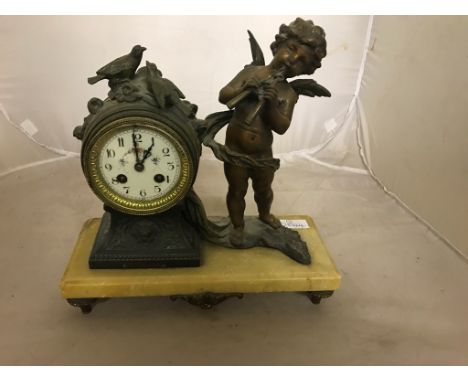 A Victorian spelter mantel clock on a marble base
