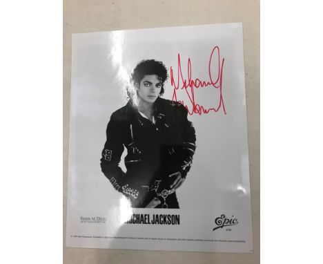A Michael Jackson promotional photograph signed in red marker given to Reg Moule, his driver, while in London