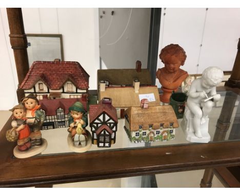 A quantity of ceramic cottages, Hummel figures and terracotta busts