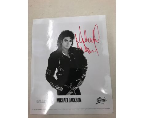 A Michael Jackson promotional photograph signed in red marker given to Reg Moule, his driver, while in London