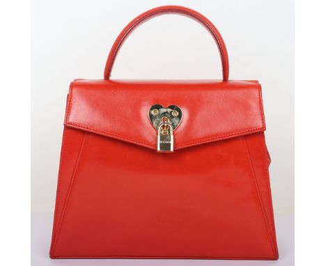 Escada Red Locket Hnadbag
Step into timeless elegance with this Vintage Escada Red Leather Bag, a striking accessory that exu