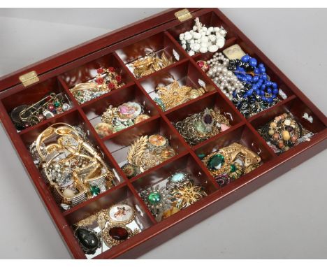 A bijouterie style case and contents of mixed costume jewellery including necklaces, stick pins and brooches including a silv