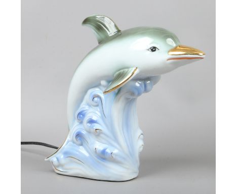 A ceramic tablelamp formed as a dolphin.