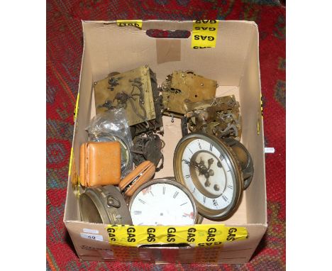 A box of assorted clock movements and dials (AF).