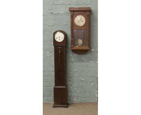 An oak cased granddaughter clock, Westminster chiming along with an oak cased wall clock.