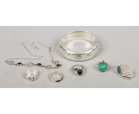 A group of mostly silver jewellery including a bangle and rings, two set with malachite.