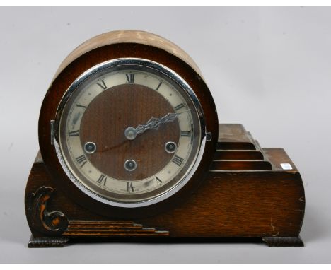 An oak cased asymmetrical mantle clock Westminster chiming (no key).