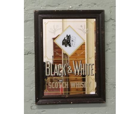 A framed vintage black and white Scotch Whisky advertising mirror.