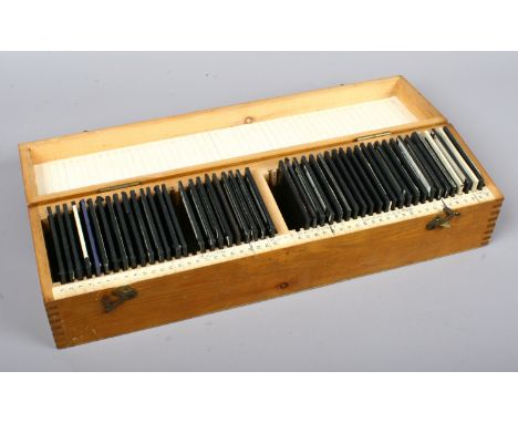A pine storage box of glass magic lantern slide with views of under ground mining and equipment.
