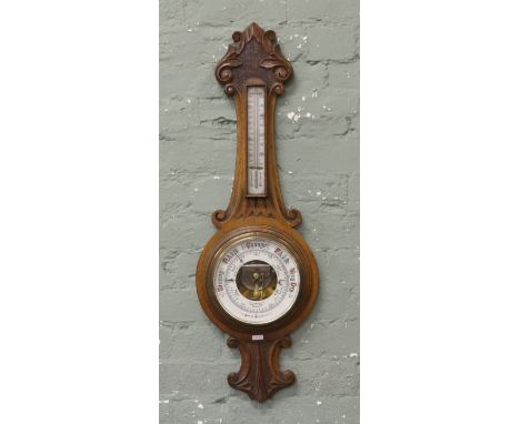 A carved oak banjo barometer.