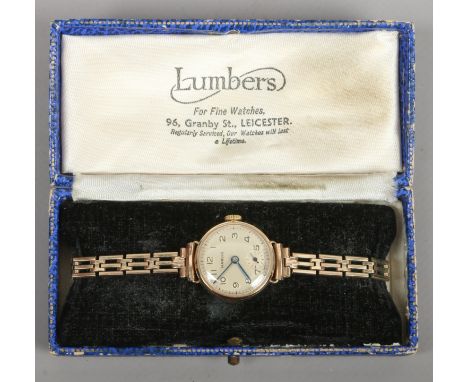 A Ladies 9ct gold manual watch on gold plated bracelet strap, with box and invoice