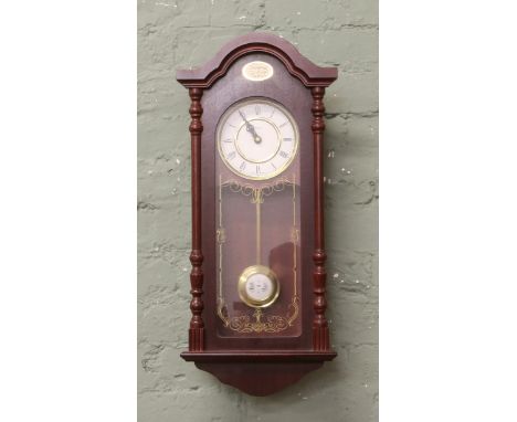 A mahogany cased Minster wall clock