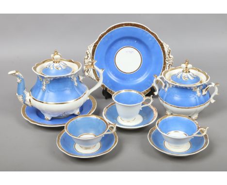 A Rockingham part tea and coffee service ground in Brunswick blue and with gilt bands comprising teapot cover and stand, sucr