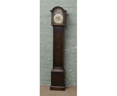 An oak cased Granddaughter clock with silvered chapter ring, Westminster chiming.