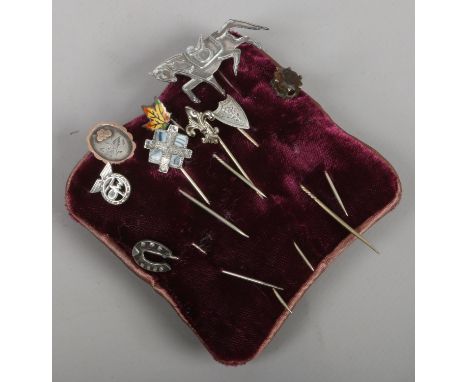 Nine silver stick pins including one gold mounted example.